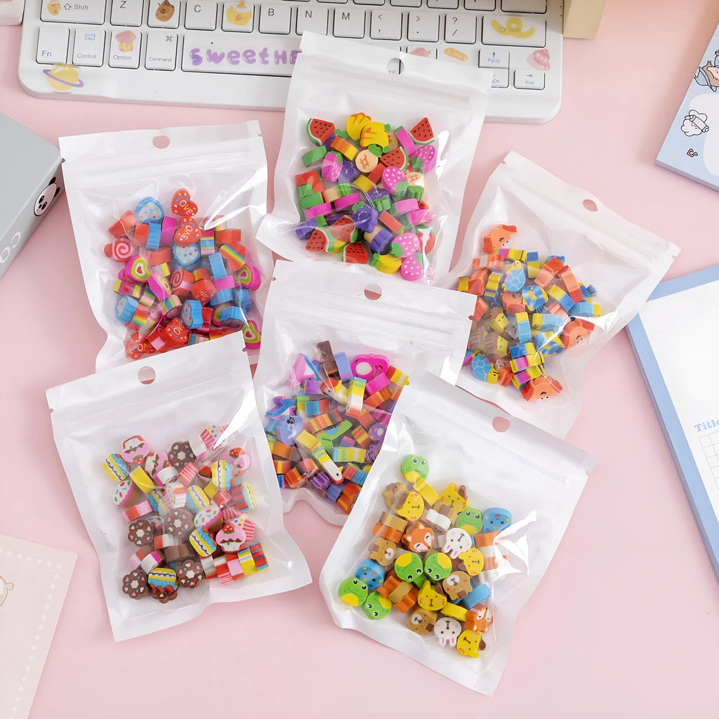 Assortment of 50 small colourful cartoon erasers showing fruit, animal, and aerospace designs.