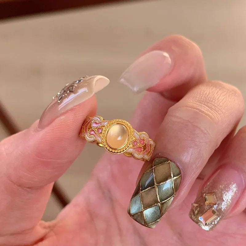 Pink crystal enamel geometric open-mouth ring on a gold-plated copper band.
