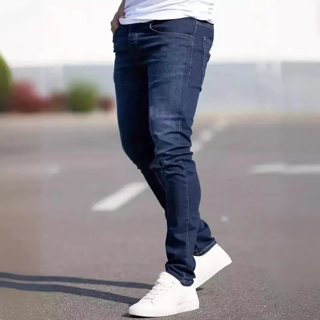 Men's dark blue slim fit cotton jeans showing skinny leg silhouette and street fashion style