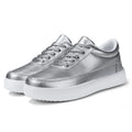 Women's white leather flat lace-up casual shoes on a plain background.
