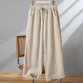 Women's straight-leg casual trousers with elastic waist and drawstring detail in apricot colour