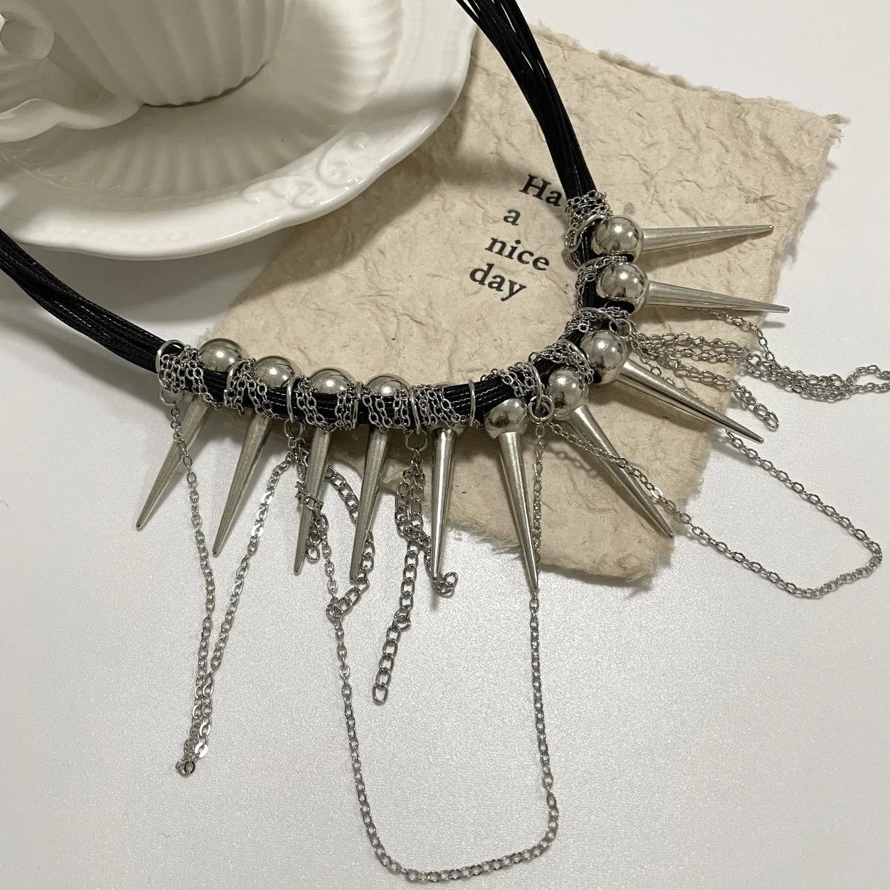 Women's leather winding tassel necklace with round beads and silver rivet details