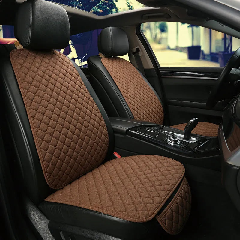 Linen universal car seat cushion with backrest in warm cream colour on a car seat.