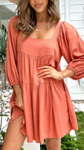 Orange backless children's dress with a square collar and puff sleeves in an A-line silhouette.