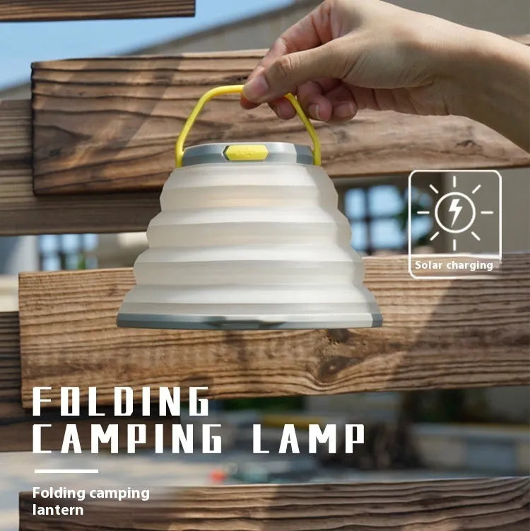 White plastic camping lamp with a large body and a single control button on the front.