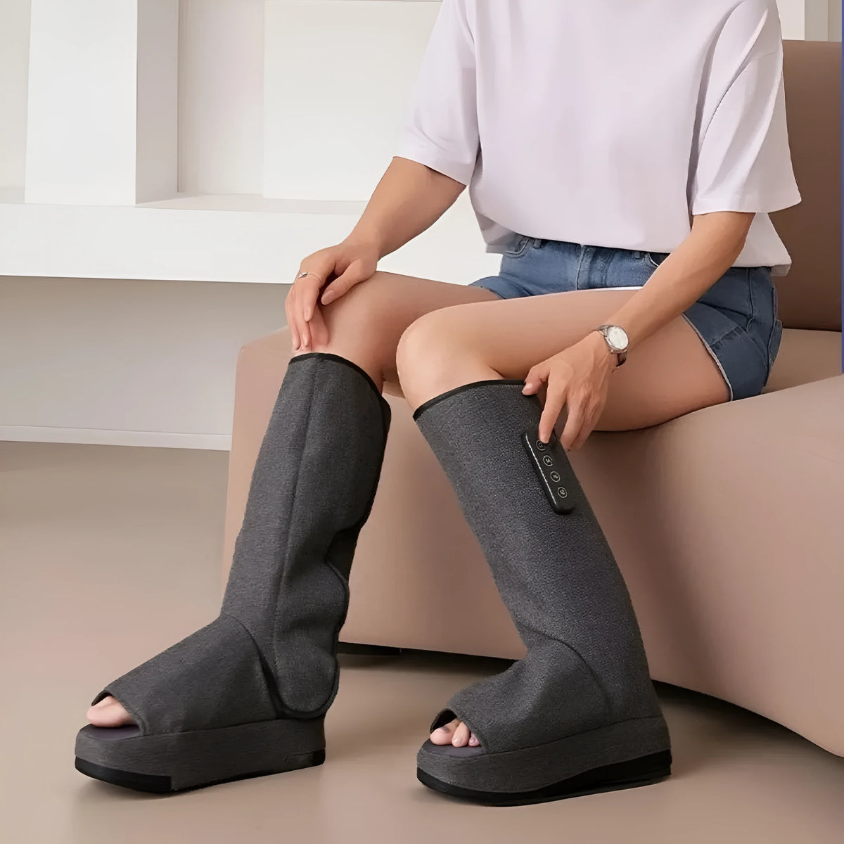 Leg massaging machine in dark gray with airbag design and USB cable