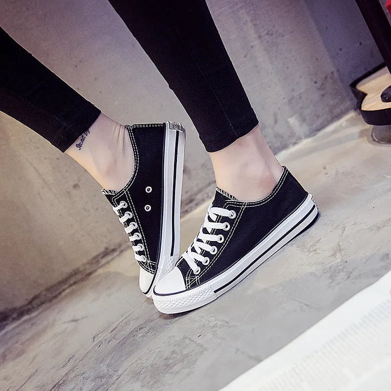 Women's casual lace-up canvas shoes in solid colours on a white background.