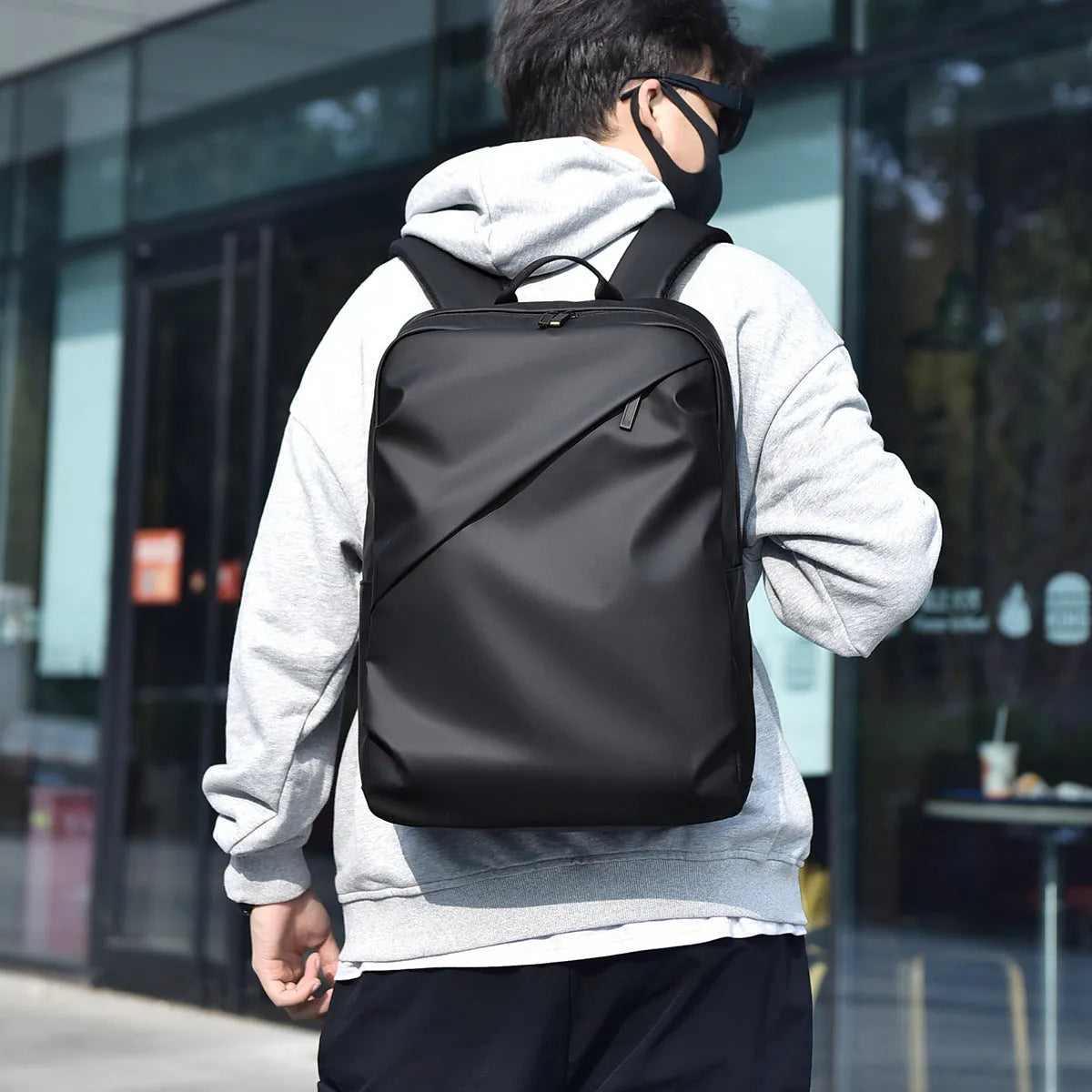 Men's waterproof PU leather backpack in black colour with computer compartment and sewing thread details