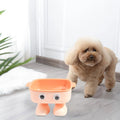 Green robot-shaped elevated cat bowl with tilted design and non-slip base