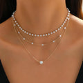 Three-layer pearl chain necklace with imitation pearl leaf, U-shaped and geometric pendants in gold and white K