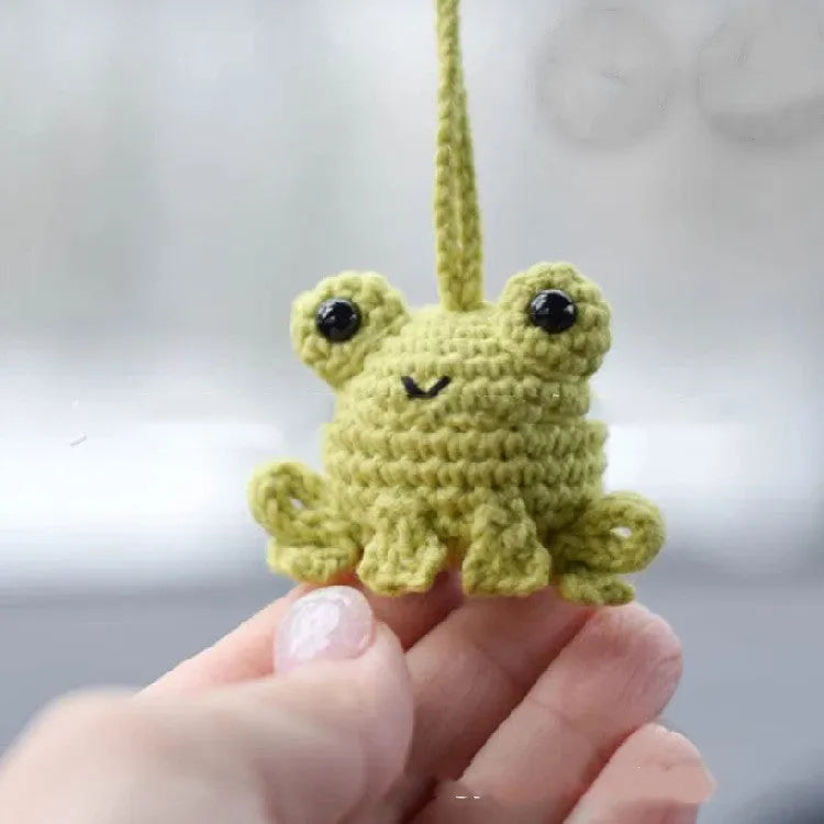 Handmade woven plush frog car pendant hanging in vehicle