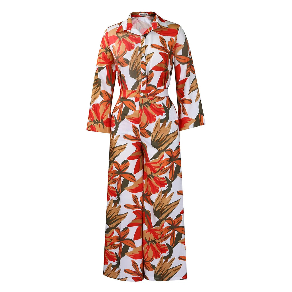 Red women's polyester printed long sleeve shirt and wide leg pants suit set laid flat.