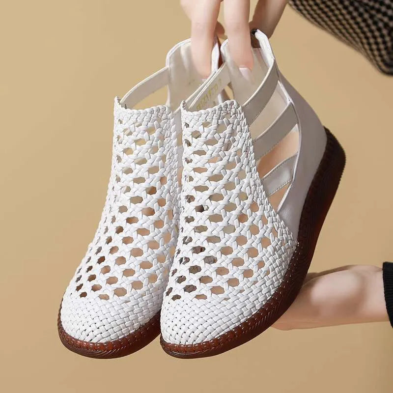 Women's flat sandals with hollow-out design and round toe in gold colour on white background