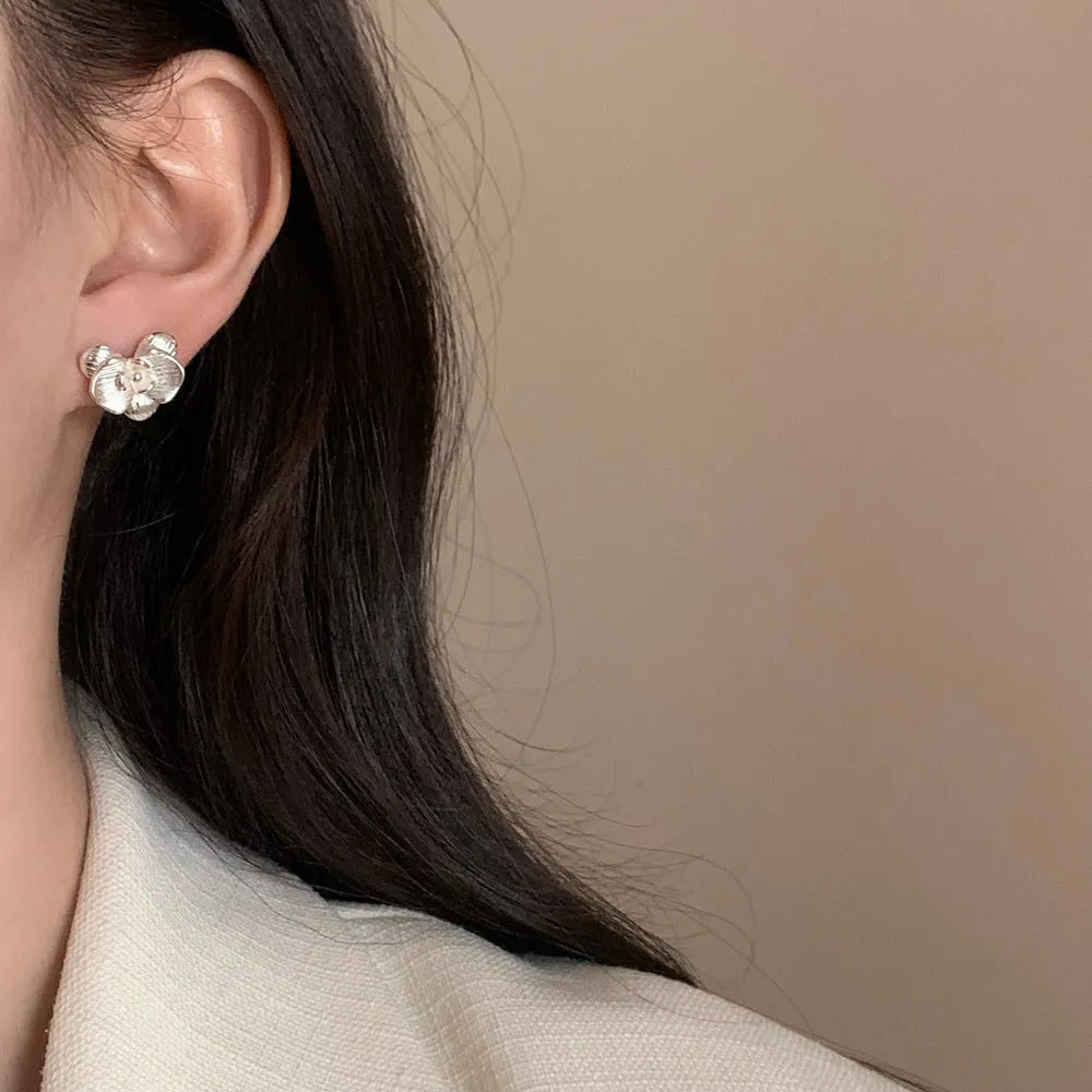 Retro flower earrings with gold or silver electroplated finishes and detailed petal design elements