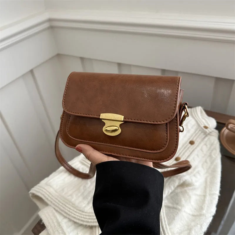 Retro-style square handbag in soft PU leather showing horizontal structure and shoulder strap