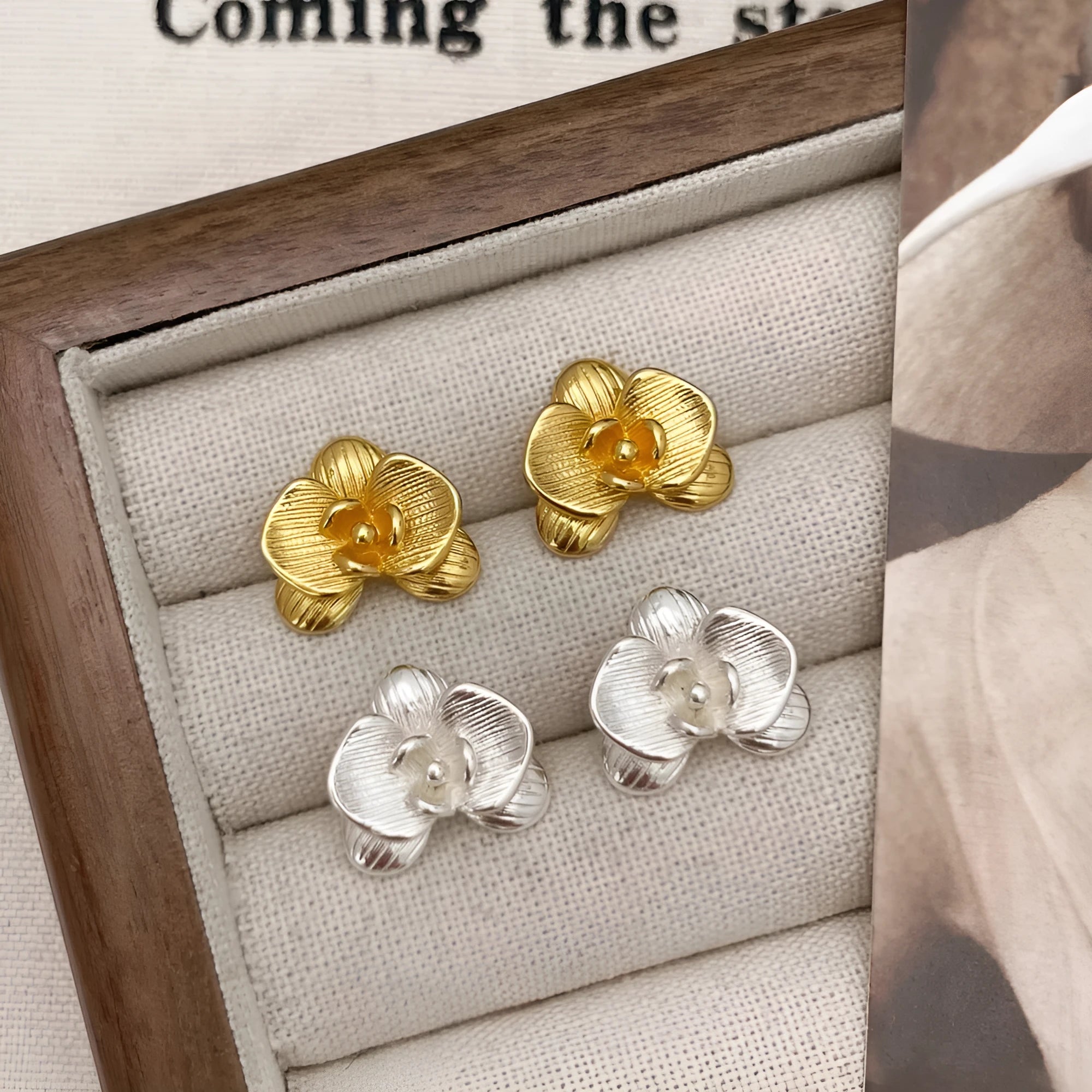 Retro flower earrings with gold or silver electroplated finishes and detailed petal design elements