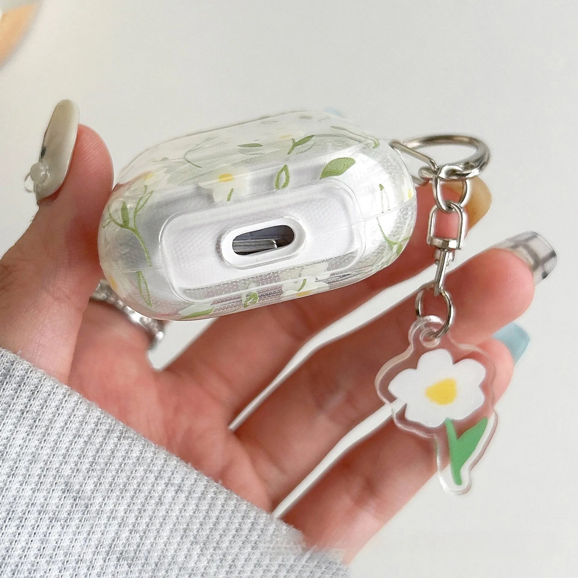 White floral high-transparent TPU protective cover for Apple AirPods on a table