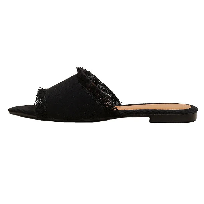 Women's denim flat slipper with tassel detail in apricot colour on a neutral background.