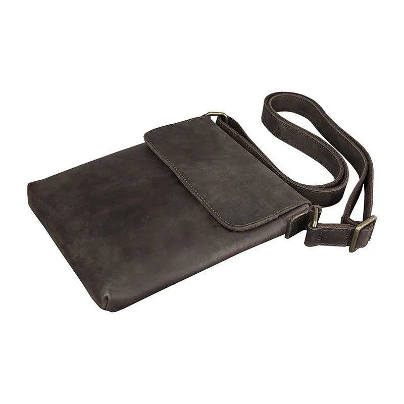 Men's brown Crazy Horse leather crossbody backpack on a plain background, showing retro design and iPad pocket