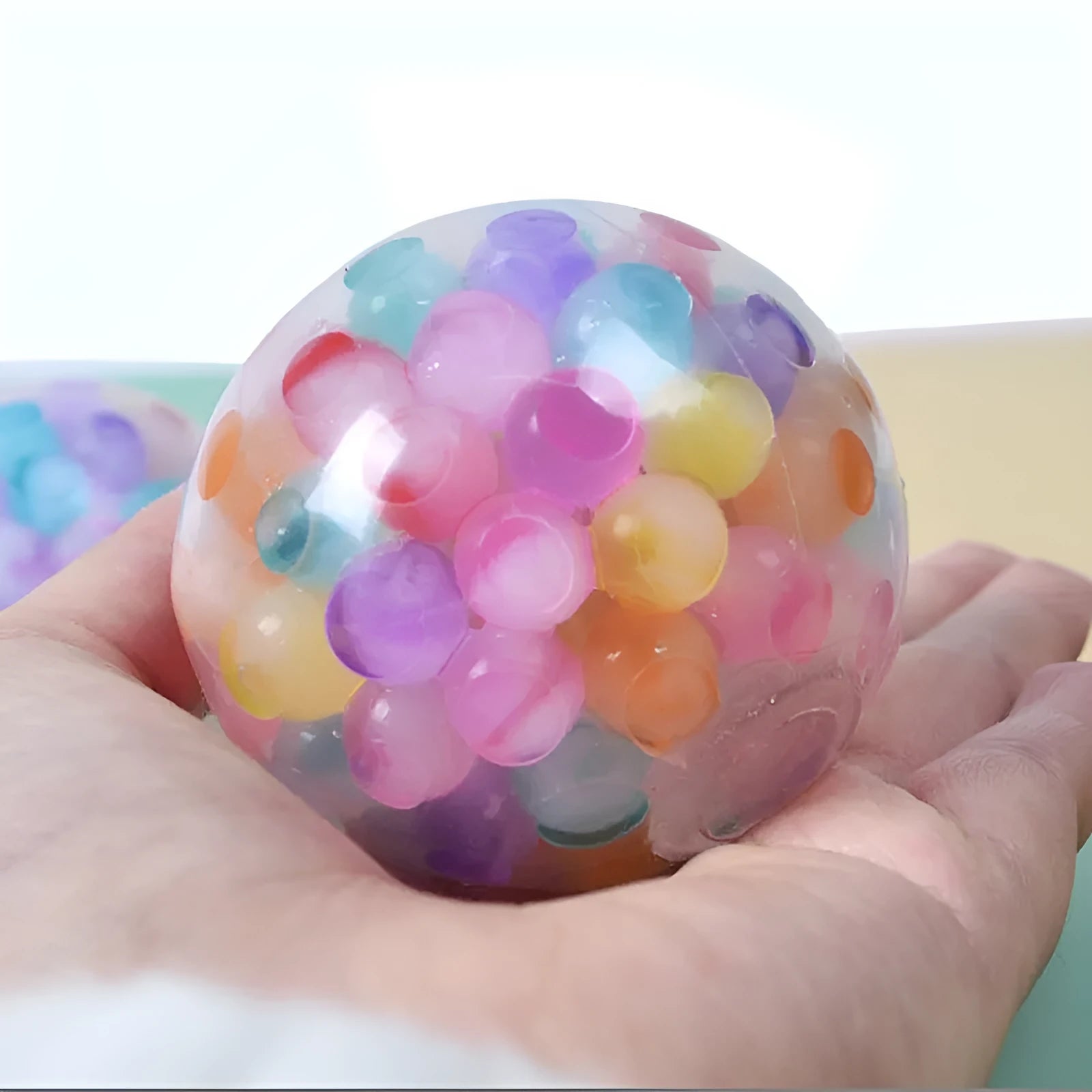 Rainbow TPR soft rubber stress ball 6cm diameter on white background OPP bag
