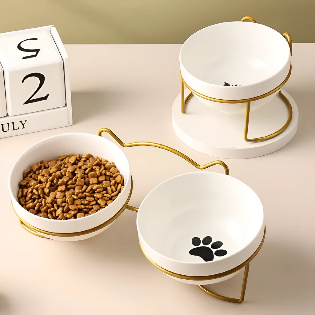 White ceramic pet bowl with cat footprint pattern in black metal frame