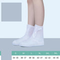 Women's white PVC high top reusable waterproof shoe covers shown on feet