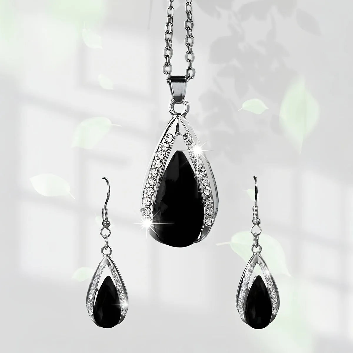 Black and red teardrop glass pendant necklace and matching earrings set made from alloy metal.