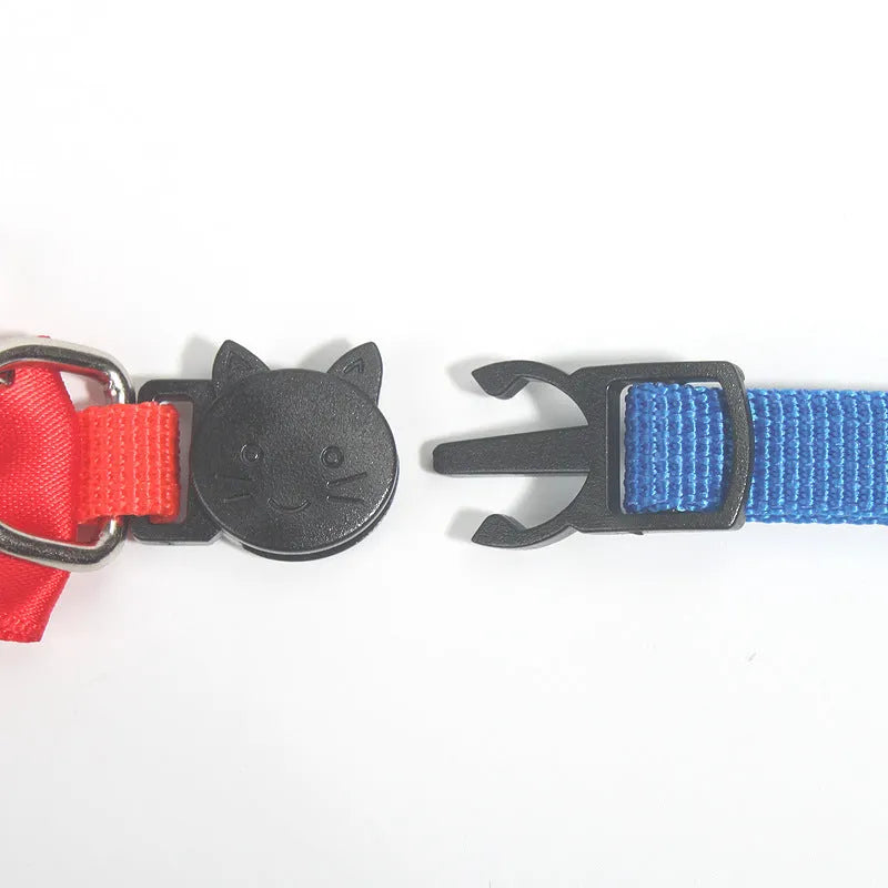 Adjustable nylon cat collar with decorative bow and bell in striped cartoon pattern, multiple colour options shown