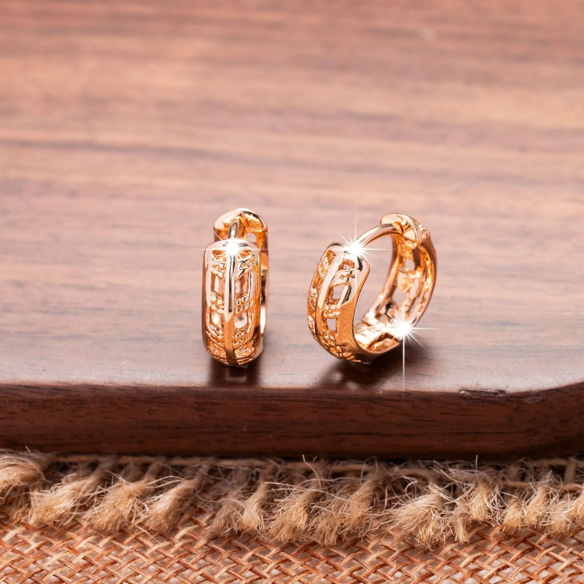 Hollowed-out copper earrings with leaf and heart designs in rose gold colour