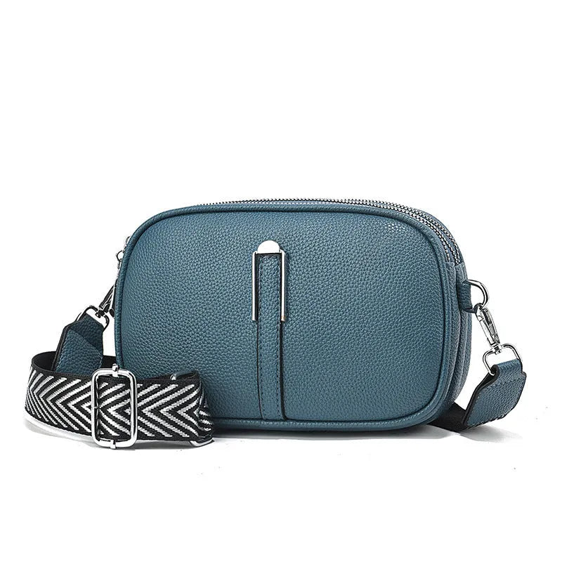 Women's soft PU crossbody bag in oval shape with interior organisation compartments