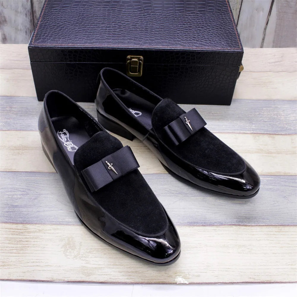 Men's glossy patent leather dress shoes with tassel detail in black, showing low-top design and leather toe holder.