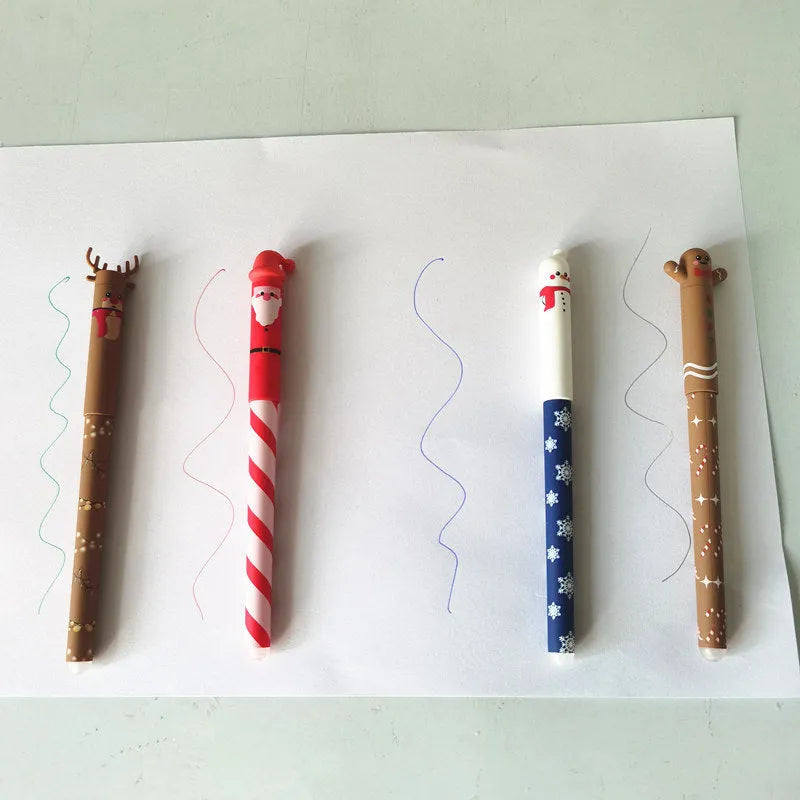 Four Christmas-themed erasable gel pens with Santa, gingerbread man, elk, and snowman designs on a white background