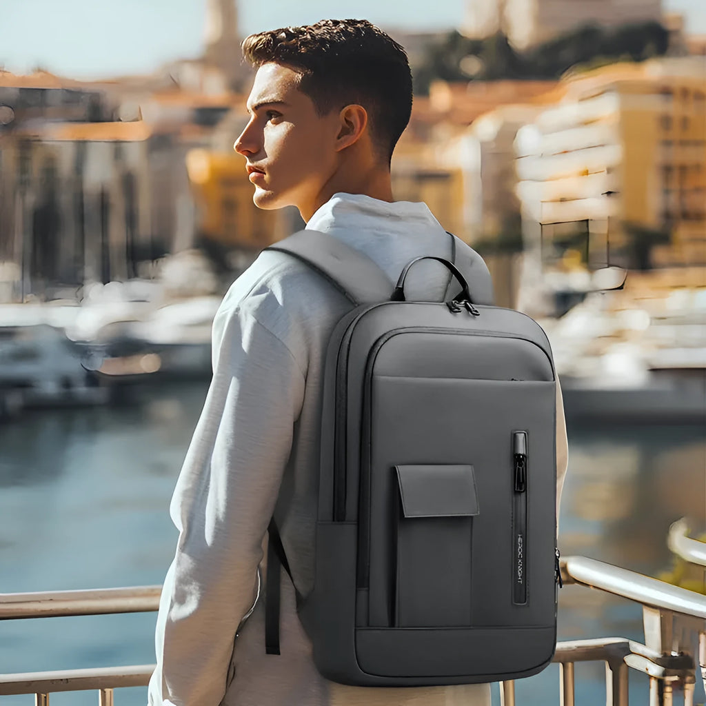 Lightweight Oxford cloth men's backpack in dark gray with sewing line detailing and thin profile