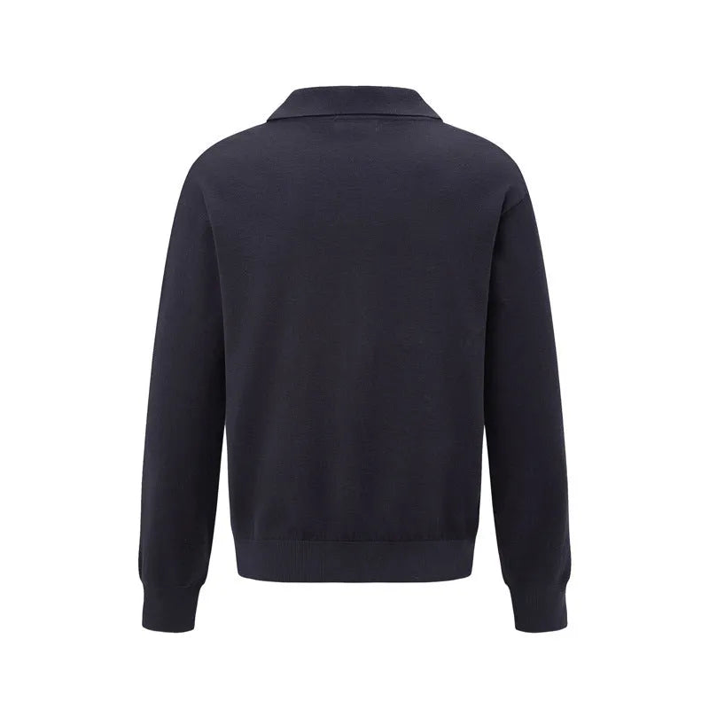 Man wearing a loose black acrylic blend pullover sweater, casual long sleeve knit top.