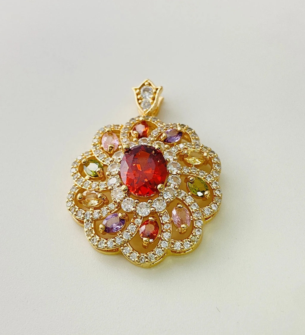 Close-up of a colourful zircon flower pendant necklace in a gold finish, showing floral detail.