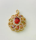 Close-up of a colourful zircon flower pendant necklace in a gold finish, showing floral detail.