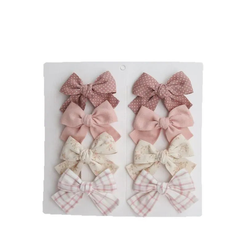 Children's fabric hairclips with dovetail bow design in multiple colour patterns