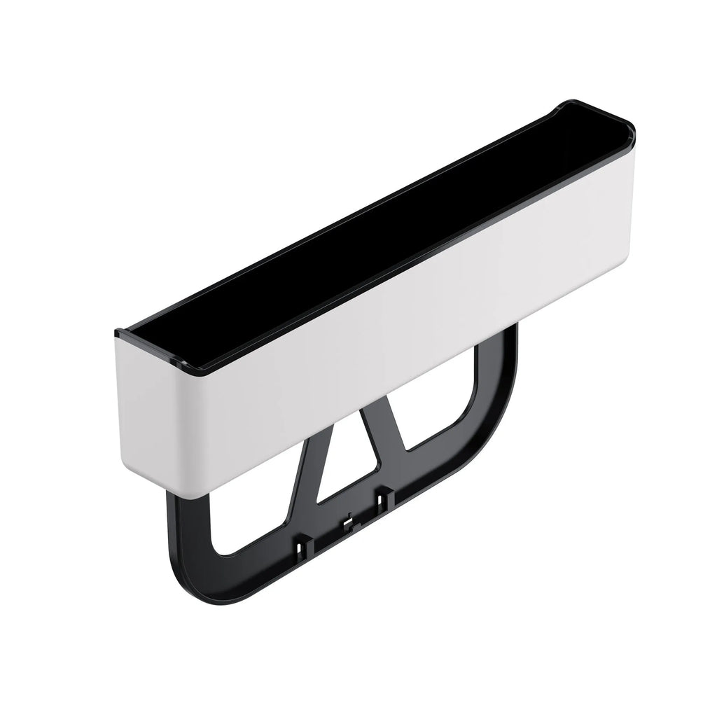 Black plastic car seat gap storage box organiser shown between vehicle front seats.