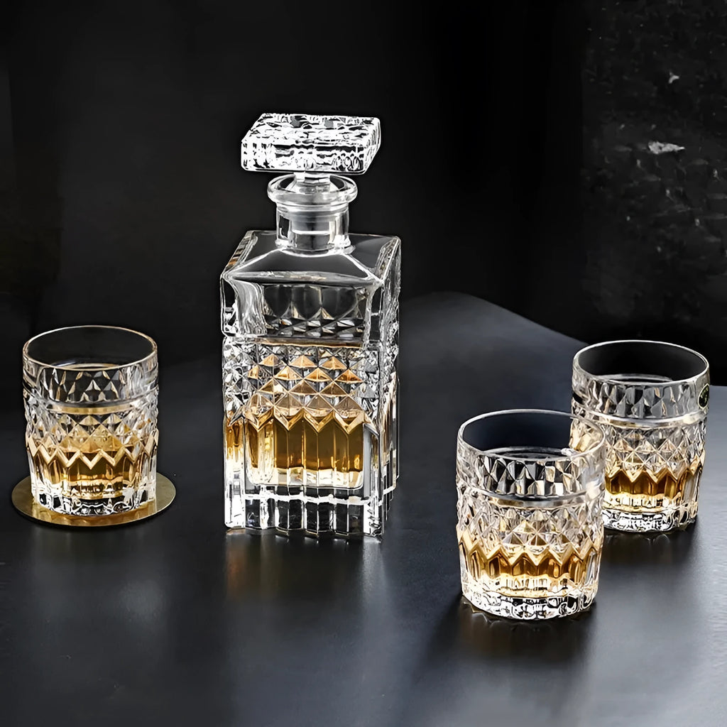 Crystal glass wine set with retro style cups and bottle on table