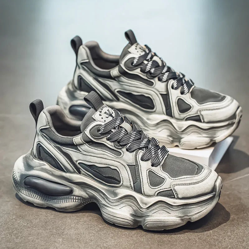 Men's low-top mesh sneakers in grey with a platform sole and lace-up front, on a white background.