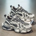 Men's low-top mesh sneakers in grey with a platform sole and lace-up front, on a white background.