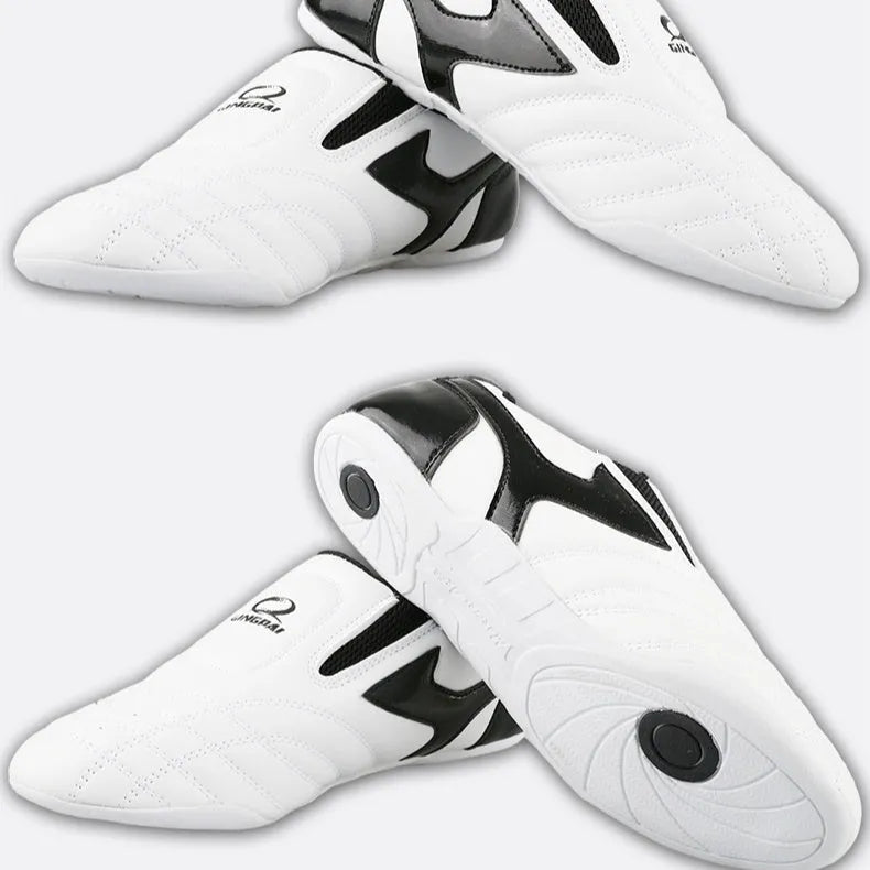 Black and white children's martial arts training shoes with a soft bottom and widened fit for Sanda and Taekwondo.
