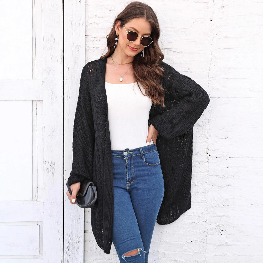 Loose-fitting women's acrylic sweater coat in a solid colour, shown on a model.