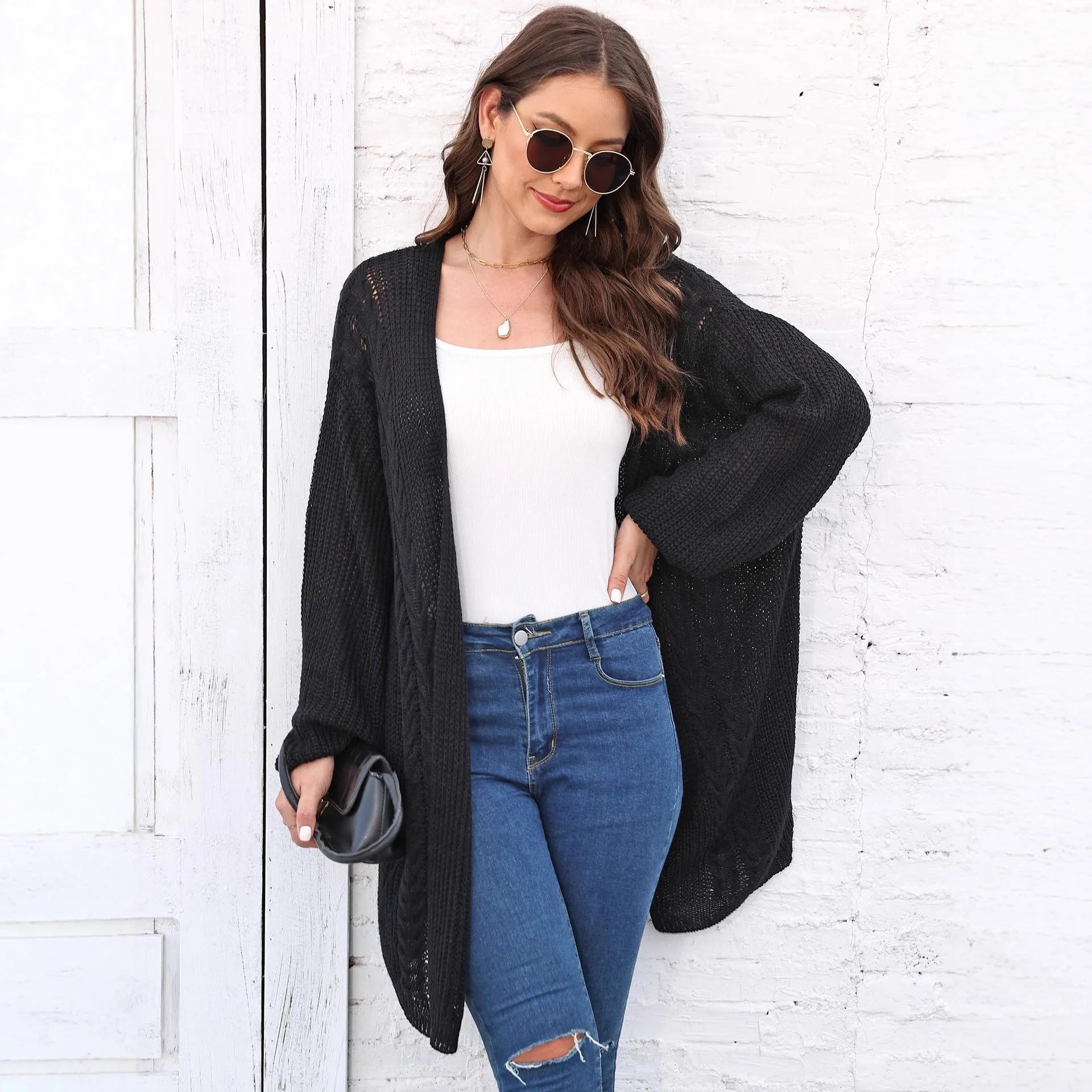 Loose-fitting women's acrylic sweater coat in a solid colour, shown on a model.