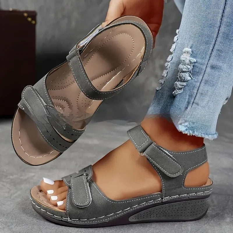 Women's beige strap sandals with a thick composite sole and adjustable Velcro fastening.