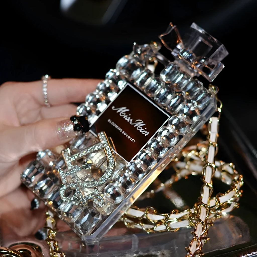 Perfume bottle bow design iPhone case with textured silicone and a metal chain strap.