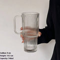 740ml hand-blown glass cup with handle, lid, and curved straw on a table
