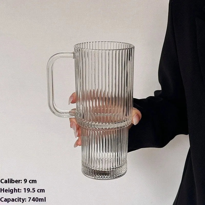 740ml hand-blown glass cup with handle, lid, and curved straw on a table