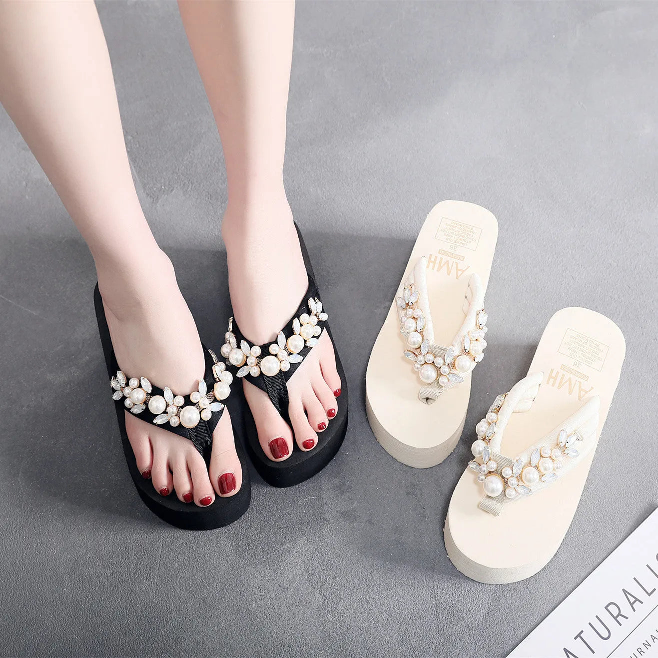 Women's high-heeled flip-flops in beige and black with cotton cloth upper.