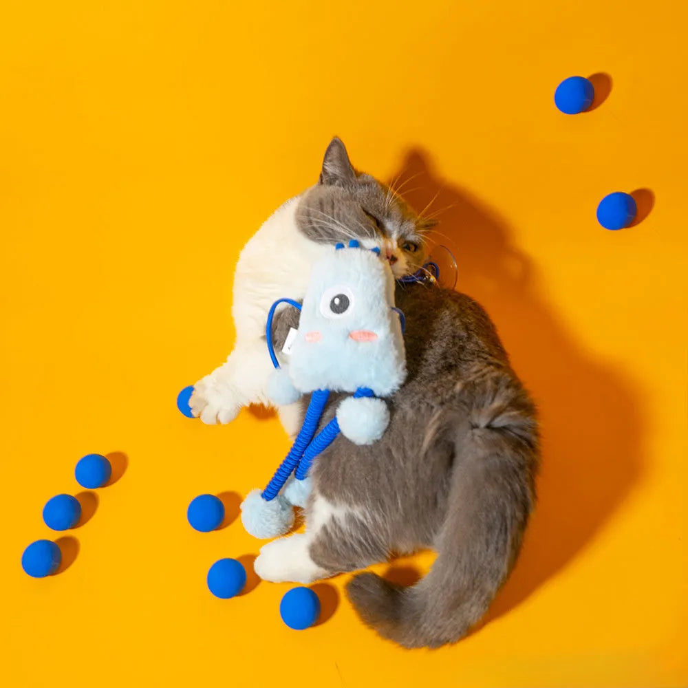 Blue plush cat toy with a telescopic elastic rope and a mint-coloured bell ring on a white surface.